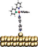 Ab Initio Calculations of the Electronic Properties of Polypyridine Transition Metal Complexes and Their Adsorption on Metal Surfaces in the Presence of Solvent and Counterions